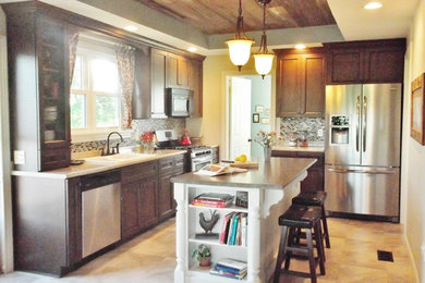 Inspiration for a mid-sized cottage l-shaped vinyl floor and beige floor eat-in kitchen remodel in Other with a drop-in sink, recessed-panel cabinets, dark wood cabinets, laminate countertops, multicolored backsplash, mosaic tile backsplash, stainless steel appliances and an island