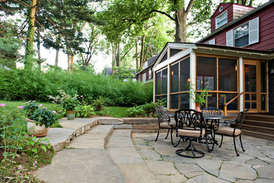 Inspiration for a large timeless backyard stone patio remodel in Baltimore with no cover