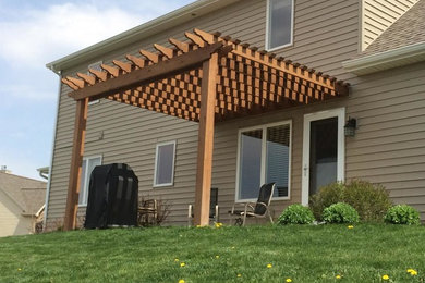 Patio - backyard patio idea in Other with a pergola