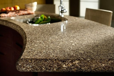 Example of a classic kitchen design in Orange County with solid surface countertops