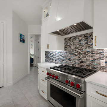 Wolf range's signature red knobs with a unique glass backsplash backdrop