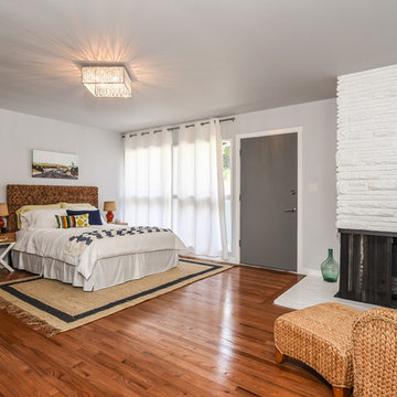 Beachy master bedroom, striped throw, seagrass chair