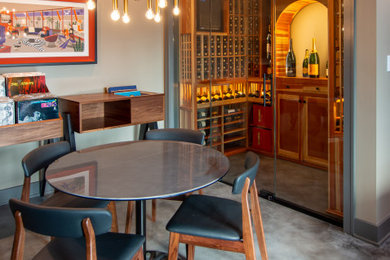Example of a mid-sized gray floor wine cellar design in Chicago with display racks
