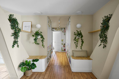 Mid-sized trendy light wood floor and wallpaper hallway photo in Nantes with beige walls