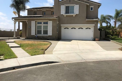 Inspiration for a mid-sized timeless brown two-story stucco exterior home remodel in San Diego with a shingle roof