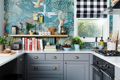 Mid-sized eclectic u-shaped dark wood floor and brown floor open concept kitchen photo in Columbus with an undermount sink, recessed-panel cabinets, blue cabinets, quartzite countertops, stainless steel appliances, an island and white countertops