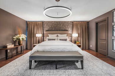 Ejemplo de dormitorio principal actual de tamaño medio con paredes marrones, suelo de madera en tonos medios, suelo marrón y papel pintado