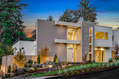 Huge contemporary white three-story exterior home idea in Seattle