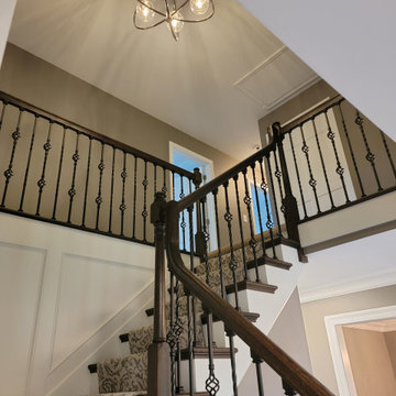 staircase with traditional wood and iron handrail