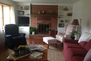 Inspiration for a mid-sized farmhouse enclosed light wood floor living room remodel in Orlando with white walls, a standard fireplace and a brick fireplace