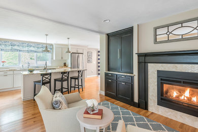 Mid-sized transitional l-shaped medium tone wood floor open concept kitchen photo in Boston with an undermount sink, beaded inset cabinets, white cabinets, granite countertops, white backsplash, subway tile backsplash, stainless steel appliances and an island
