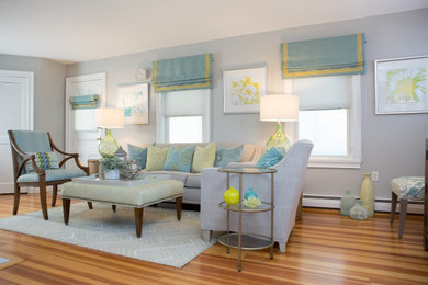 Inspiration for a mid-sized transitional open concept medium tone wood floor and brown floor living room remodel in Boston with gray walls, a standard fireplace, a tile fireplace and a wall-mounted tv