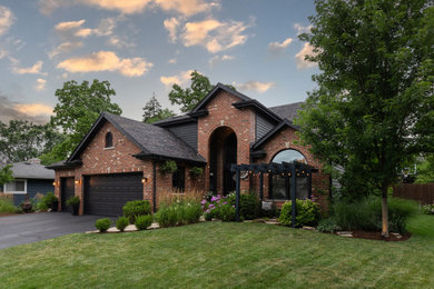 Inspiration for a large transitional black two-story wood exterior home remodel in Chicago with a shingle roof and a black roof