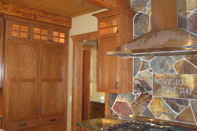 Mid-sized arts and crafts l-shaped enclosed kitchen photo in Sacramento with shaker cabinets, medium tone wood cabinets, granite countertops, multicolored backsplash, stone tile backsplash, stainless steel appliances and an island