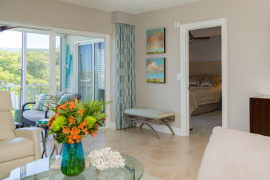 Mid-sized beach style open concept black floor living room photo in Miami with beige walls, no fireplace and no tv