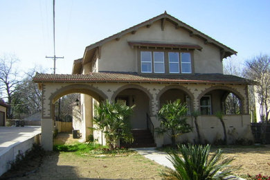 Large tuscan beige two-story stucco exterior home photo in Dallas