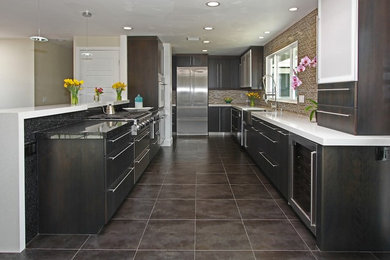 Inspiration for a mid-sized contemporary galley ceramic tile kitchen pantry remodel in San Diego with a farmhouse sink, flat-panel cabinets, dark wood cabinets, granite countertops, brown backsplash, matchstick tile backsplash, stainless steel appliances and no island