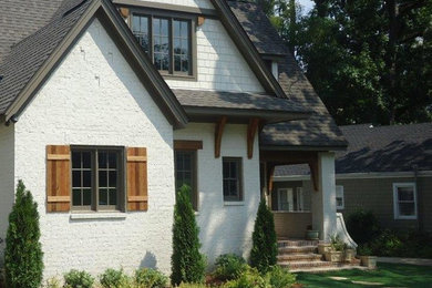 Example of a mid-sized arts and crafts white two-story brick exterior home design in Birmingham