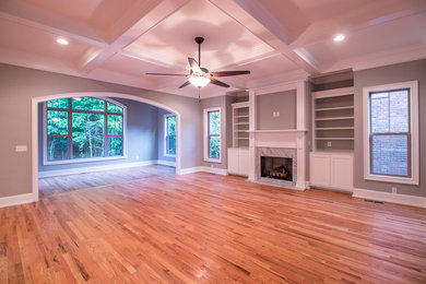 Large transitional formal and open concept light wood floor and brown floor living room photo in Other with gray walls, a standard fireplace, a stone fireplace and no tv