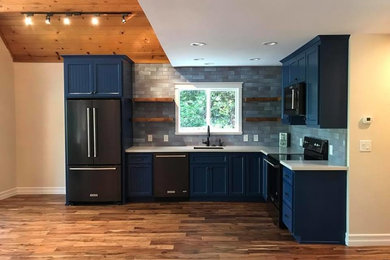 Small eclectic l-shaped medium tone wood floor and brown floor open concept kitchen photo in Sacramento with an undermount sink, blue cabinets, quartz countertops, blue backsplash, subway tile backsplash and no island
