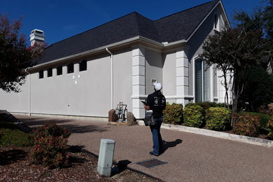 Example of a tuscan gray stucco exterior home design in Dallas