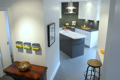Inspiration for a mid-sized contemporary u-shaped ceramic tile enclosed kitchen remodel in Ottawa with a drop-in sink, flat-panel cabinets, gray cabinets, quartz countertops, gray backsplash, glass tile backsplash, stainless steel appliances and an island