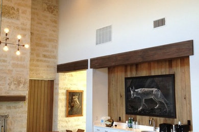 Living room - mid-sized contemporary formal and open concept concrete floor living room idea in Austin with white walls, a standard fireplace, a stone fireplace and a wall-mounted tv
