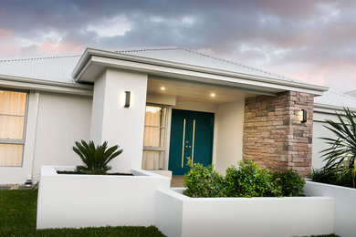Design ideas for a contemporary one-storey white exterior in Perth with stone veneer.