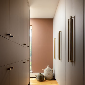 Primary Suite Dressing Area with Wall-to-Wall Custom Wardrobes