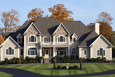 Inspiration for a large transitional two-storey beige exterior in New York with mixed siding.