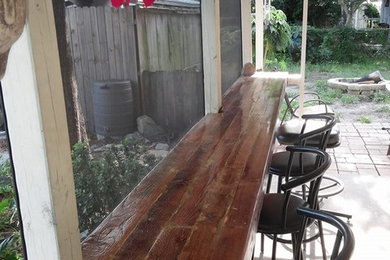 Inspiration for a mid-sized coastal home bar remodel in Tampa