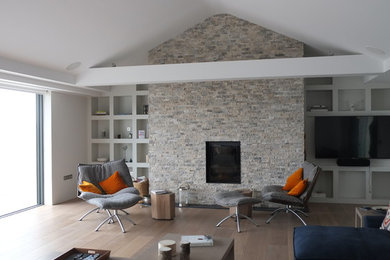 Photo of a large contemporary open plan living room in Devon with a brick fireplace surround.