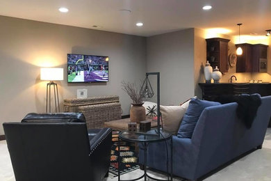Example of a mid-sized mountain style open concept carpeted and beige floor game room design in Other with gray walls, no fireplace and a wall-mounted tv