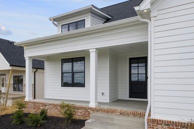 Photo of a country one-storey white house exterior in Louisville with concrete fiberboard siding.