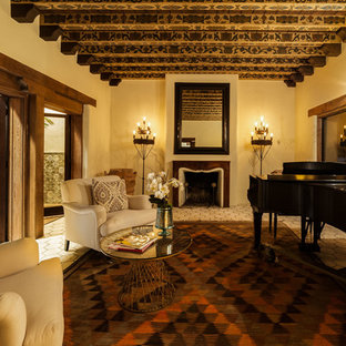 This is an example of a large mediterranean open plan living room in Los Angeles with a music area, beige walls, a standard fireplace, a wooden fireplace surround and no tv.