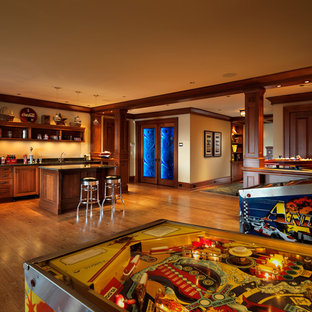 Design ideas for a classic fully buried basement in Vancouver with beige walls, medium hardwood flooring and no fireplace.