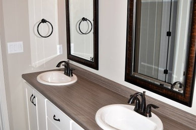 Inspiration for a gray tile bathroom remodel in Other with flat-panel cabinets, white cabinets and laminate countertops