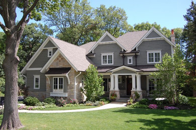 Inspiration for a large transitional gray two-story mixed siding house exterior remodel in Chicago with a hip roof and a mixed material roof