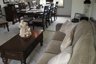 Example of a large classic formal and enclosed carpeted and gray floor living room design in Indianapolis with gray walls, a standard fireplace, a wood fireplace surround and no tv