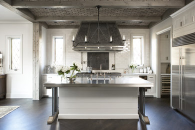 Inspiration for a large transitional galley open plan kitchen in Other with a farmhouse sink, shaker cabinets, white cabinets, marble benchtops, white splashback, subway tile splashback, stainless steel appliances, dark hardwood floors and with island.