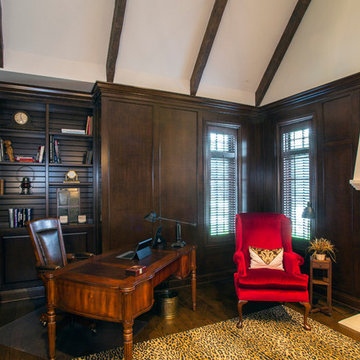 Knotty cherry home office with limestone fireplace and freestanding desk