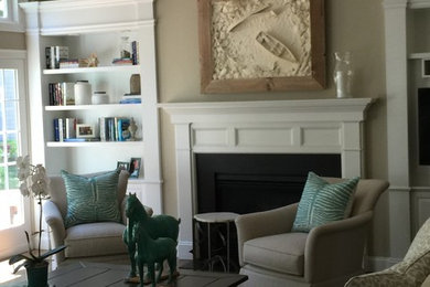 Example of a mid-sized transitional enclosed carpeted and gray floor family room design in Boston with beige walls, a standard fireplace, a wood fireplace surround and no tv