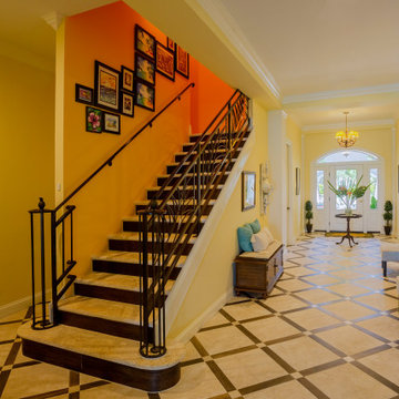 Elegant Foyer With Custom Staircase and Intricate Railing Design