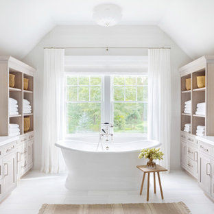 Example of a huge classic master white tile white floor bathroom design in New York with recessed-panel cabinets, light wood cabinets, a one-piece toilet, white walls, an integrated sink, marble countertops, a hinged shower door and white countertops