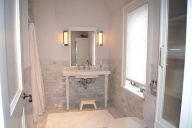 Inspiration for a mid-sized timeless 3/4 white tile and marble tile marble floor, white floor and single-sink bathroom remodel in Toronto with white cabinets, a one-piece toilet, white walls, an integrated sink, marble countertops, white countertops, a niche and a freestanding vanity