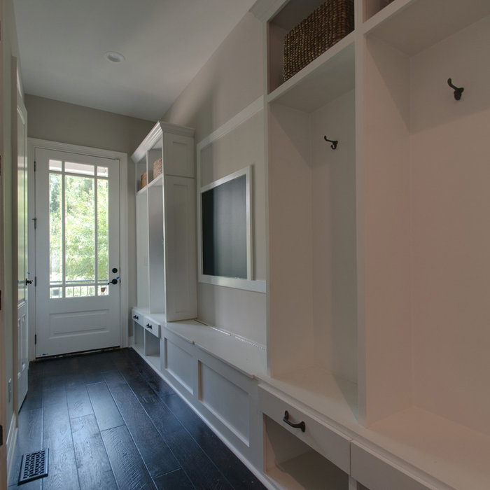 This second entry/vestibule to the home, was originally just an open hallway. By designing and incorporating  a customized cubby system for each family member, USI was able to create a space that enco