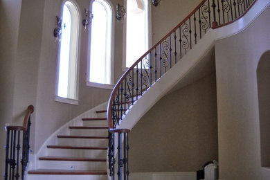 Inspiration for a large timeless wooden curved staircase remodel in Charlotte with painted risers