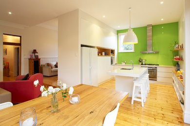 Design ideas for a contemporary kitchen/dining combo in Melbourne with white walls and light hardwood floors.