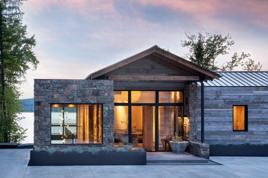 Example of a huge mountain style gray two-story mixed siding house exterior design in Other with a mixed material roof