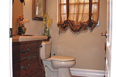 Example of a small tuscan kids' porcelain tile and multicolored floor bathroom design in Jacksonville with furniture-like cabinets, dark wood cabinets, a two-piece toilet, beige walls and solid surface countertops